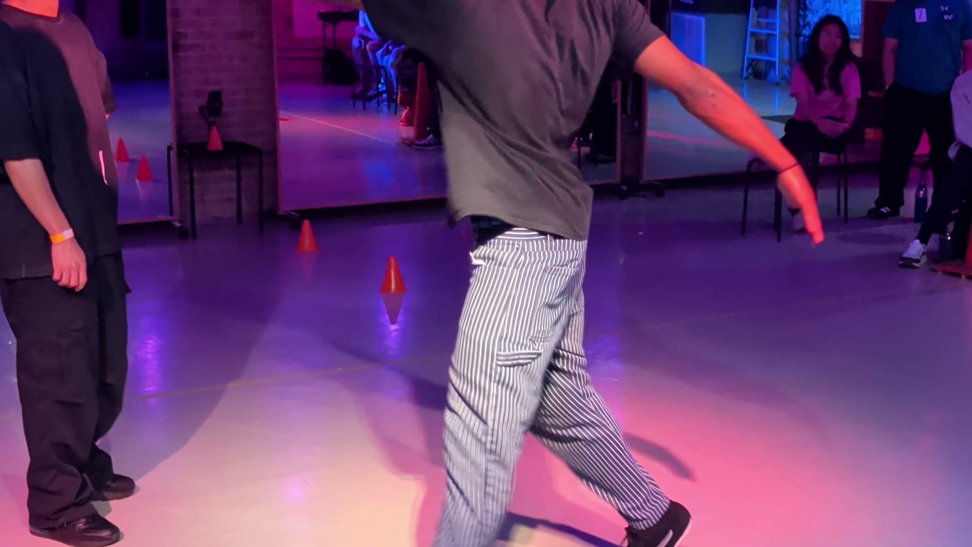 Dancer taking a turn in the circle at a Danzversity cypher night