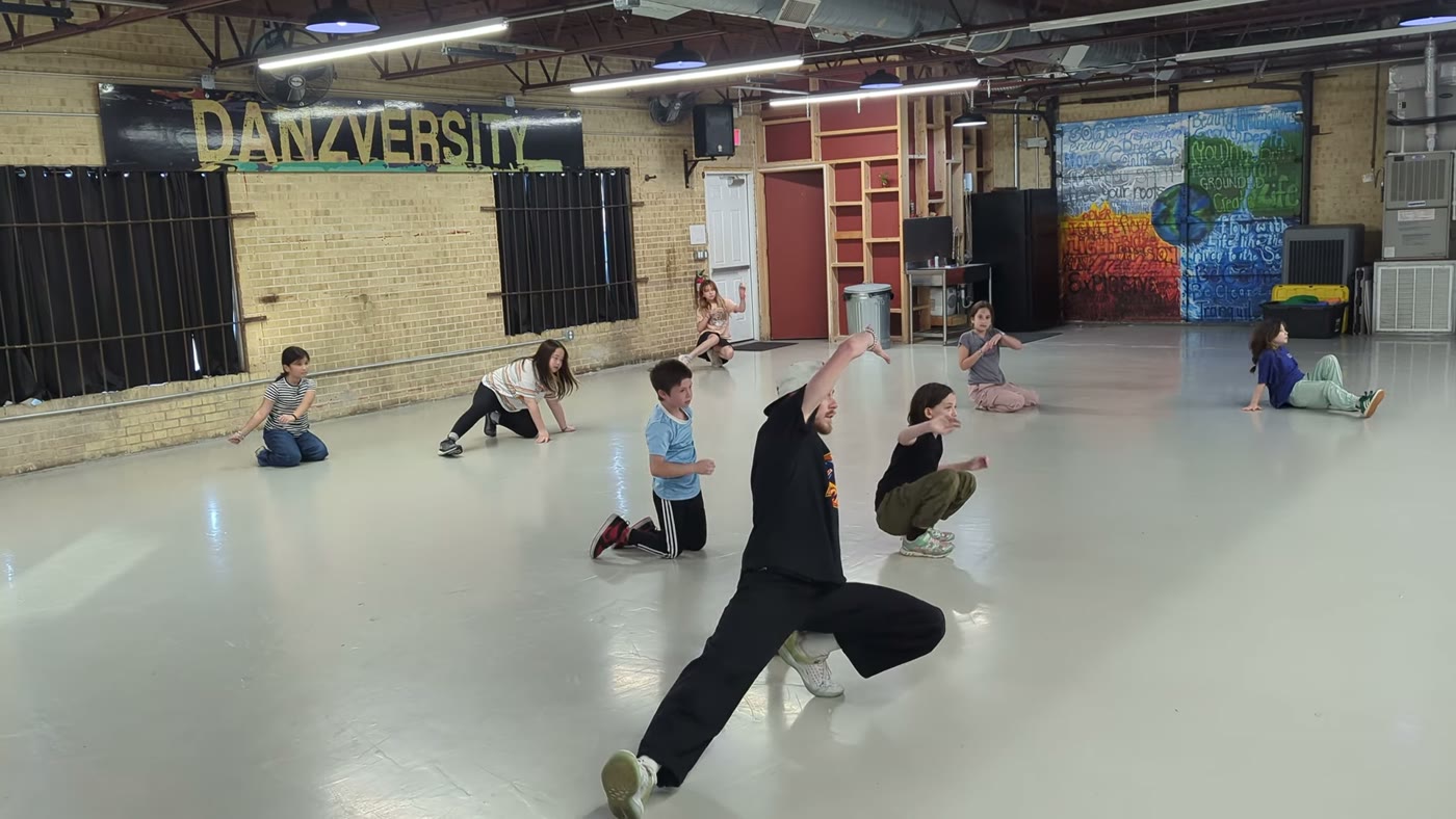 Danzversity instructor demonstrating a breakin freeze while students watch