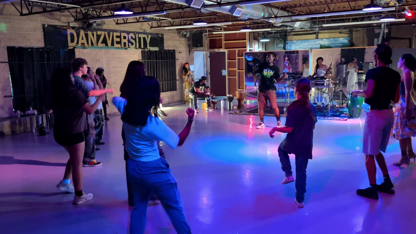 Kids and adults dancing together at Danzversity