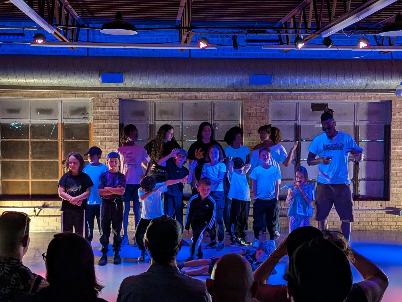 Crew under blue lights mid-routine