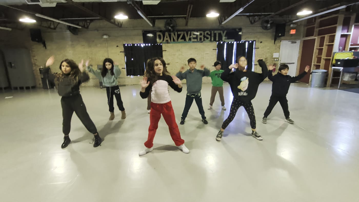 Vibe Builders class ages 8 to 12 dancing under the Danzversity sign
